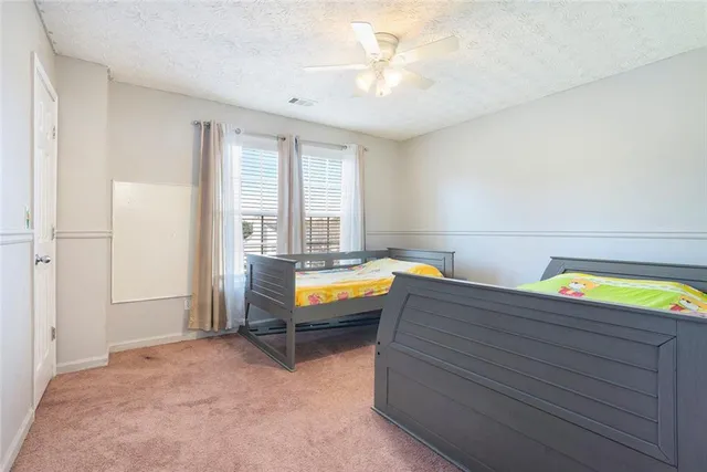 a room with stairs and a chandelier fan