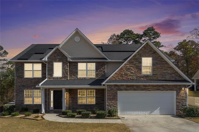 a front view of a house with yard