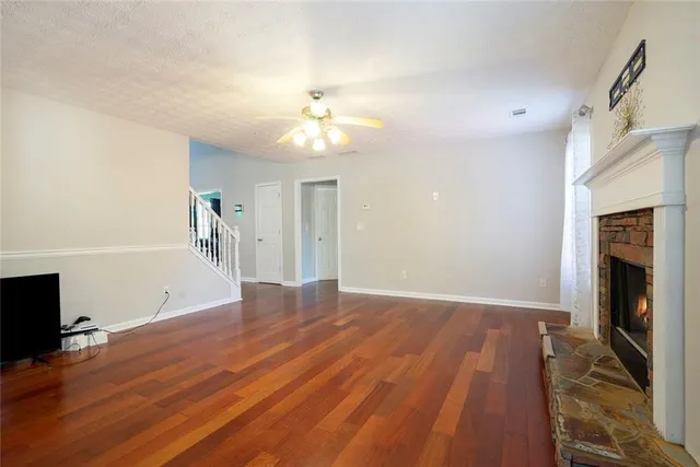 wooden floor in an empty room with a fireplace