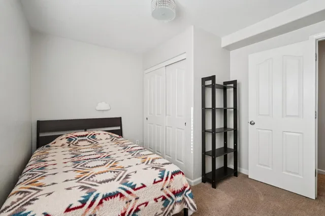 a bedroom with a bed and a book shelf