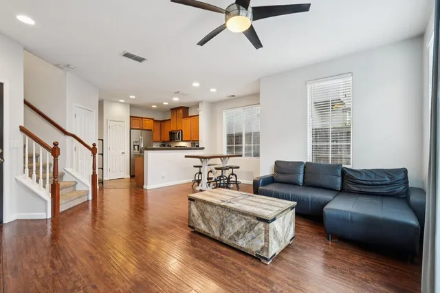 a living room with furniture and a wooden floor
