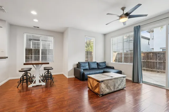 a living room with furniture and wooden floor