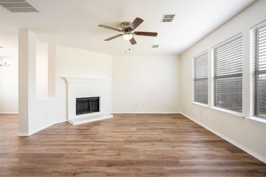 1626 White Oak Road Anna, TX 75409 - Photo 16 of 30 a view of empty room with wooden floor and fireplace