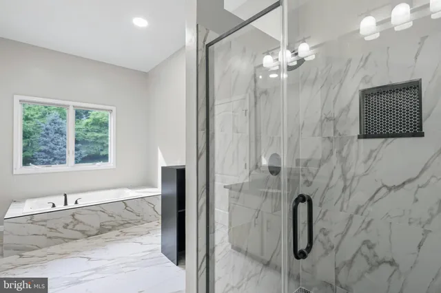 a bathroom with a bathtub and shower