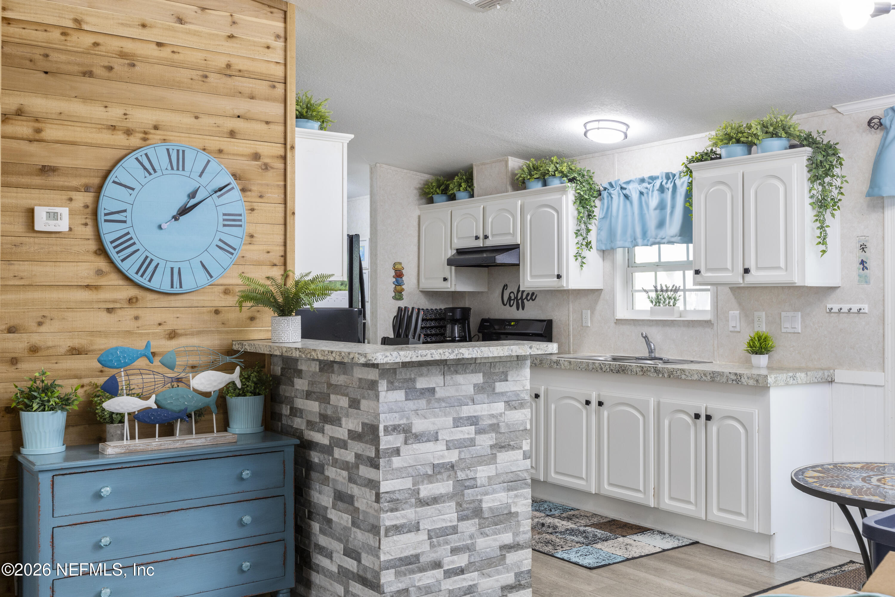 167 West Strickland Road Interlachen, FL 32148 - Photo 13 of 59 a kitchen with stainless steel appliances granite countertop a sink a stove and cabinets