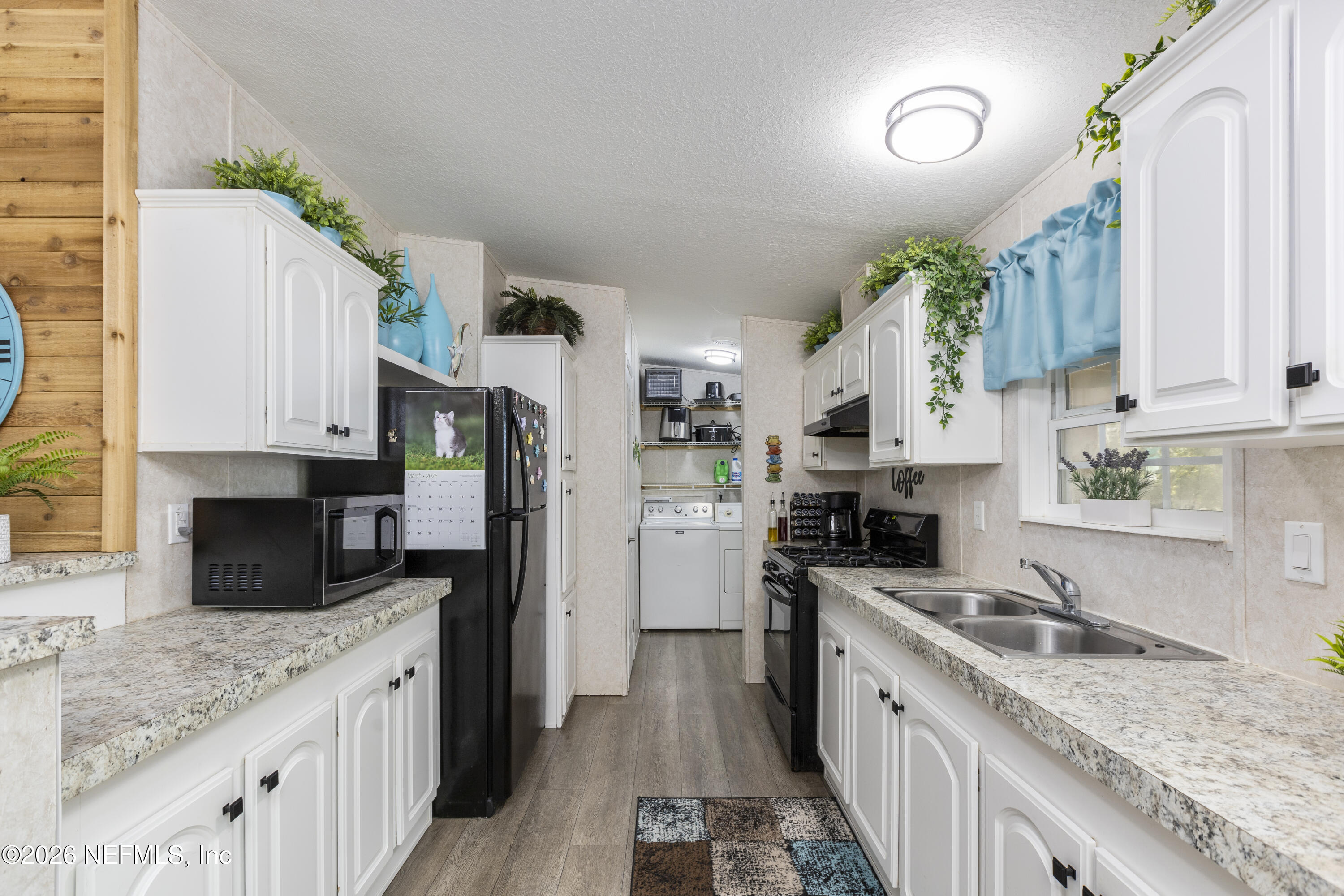 167 West Strickland Road Interlachen, FL 32148 - Photo 14 of 59 a kitchen with stainless steel appliances granite countertop a sink stove refrigerator and cabinets