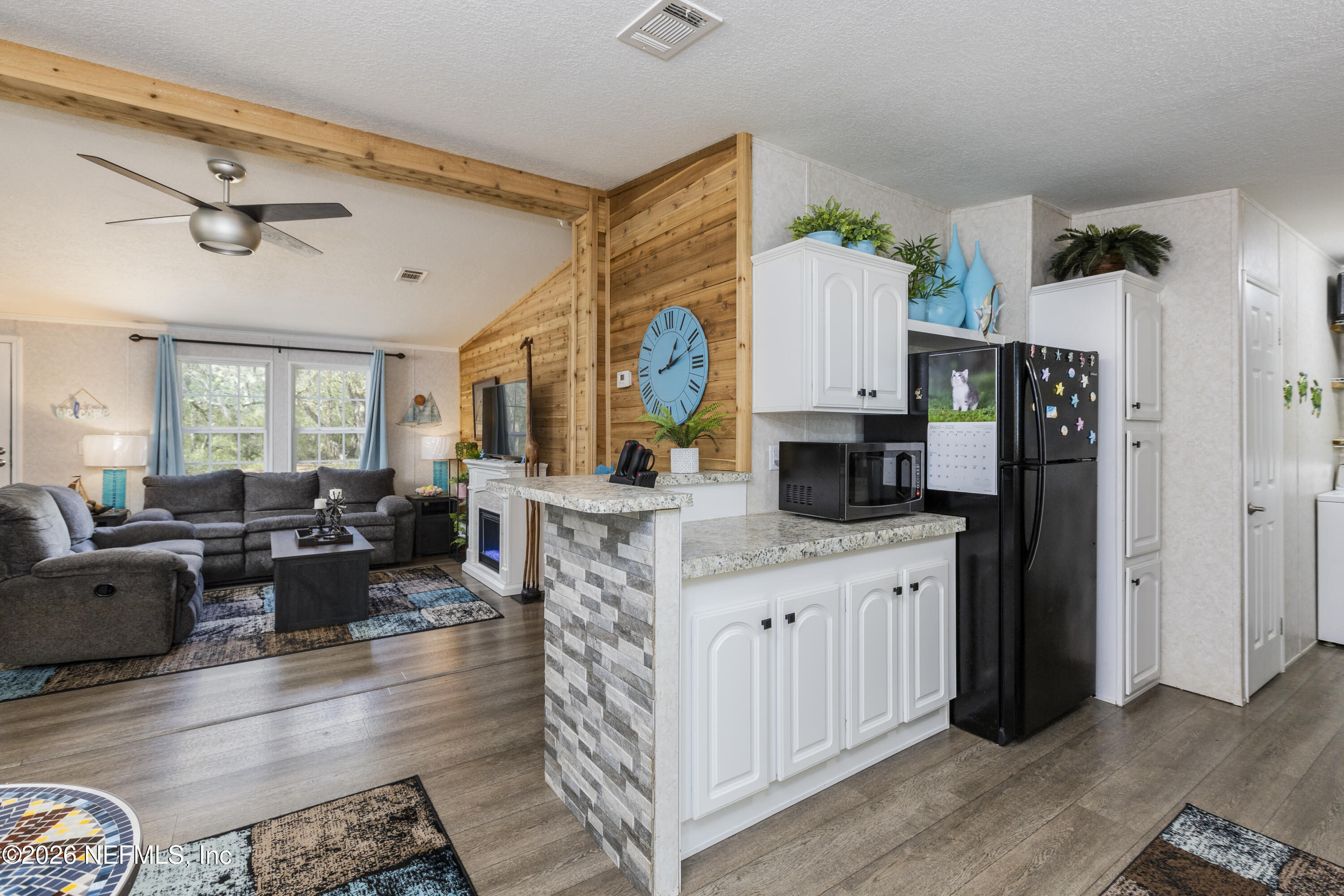 167 West Strickland Road Interlachen, FL 32148 - Photo 15 of 59 a living room with furniture a fireplace and a table