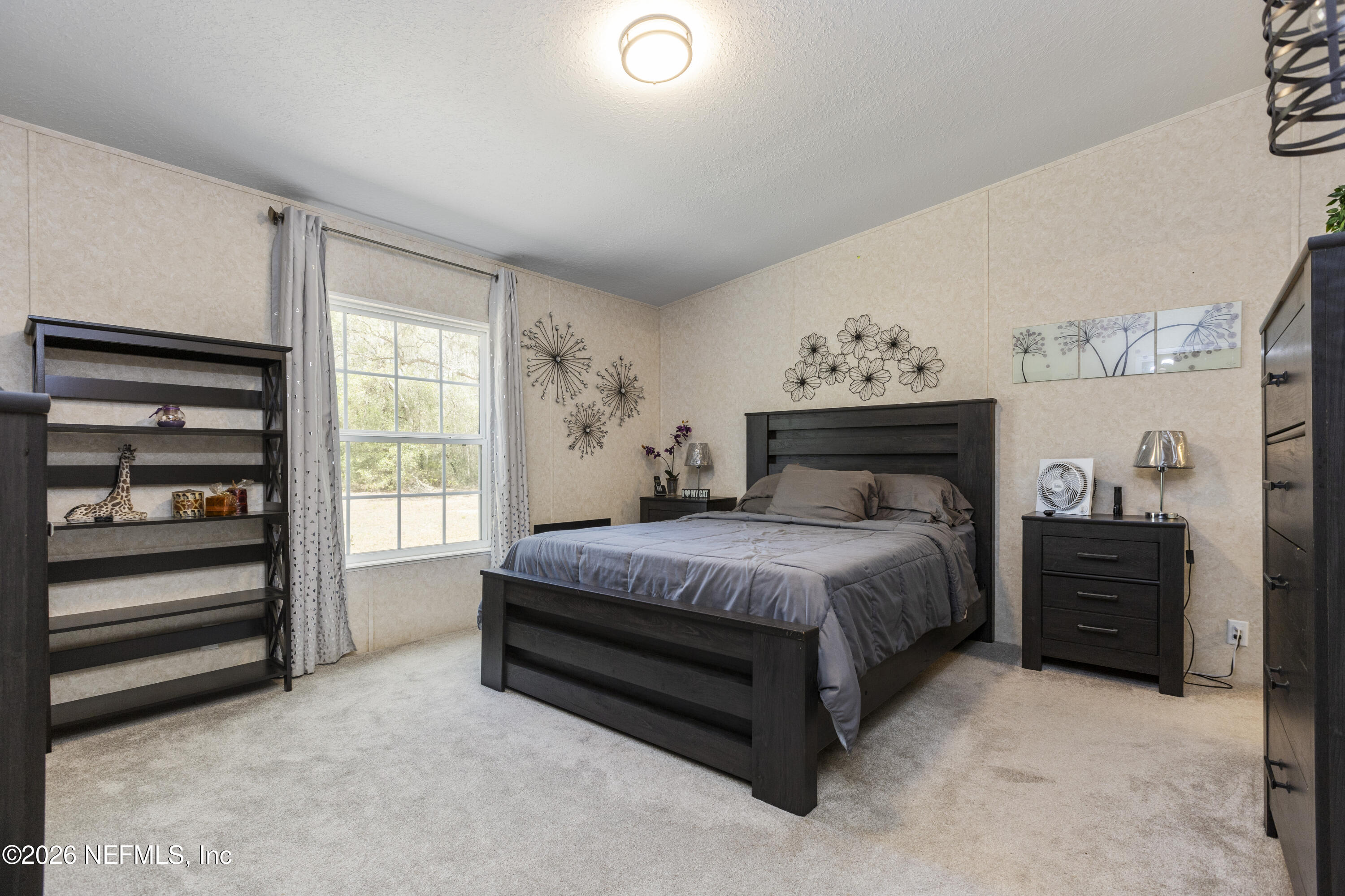 167 West Strickland Road Interlachen, FL 32148 - Photo 34 of 59 a spacious bedroom with a bed and a window