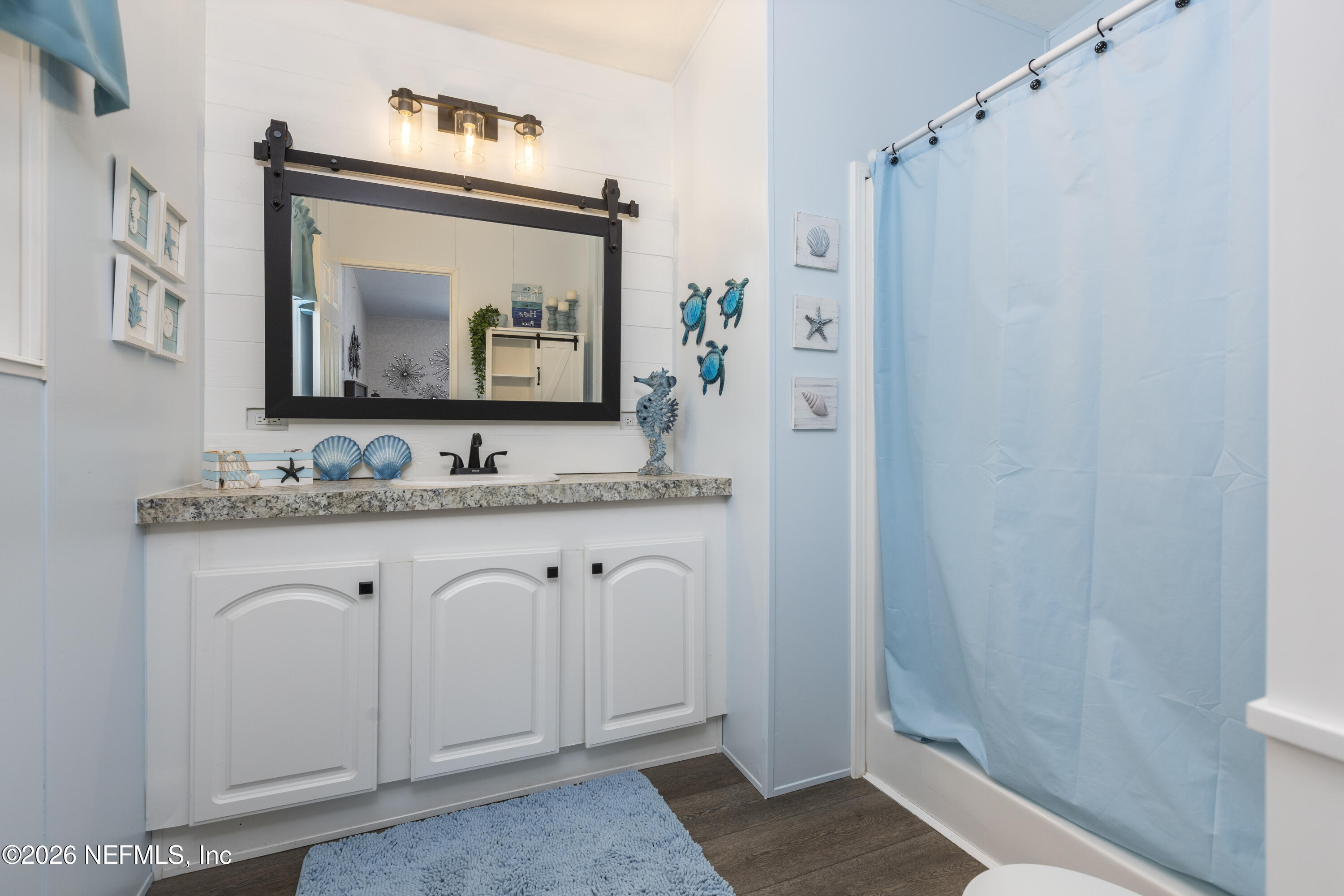 167 West Strickland Road Interlachen, FL 32148 - Photo 38 of 59 a bathroom with a granite countertop sink a mirror and shower
