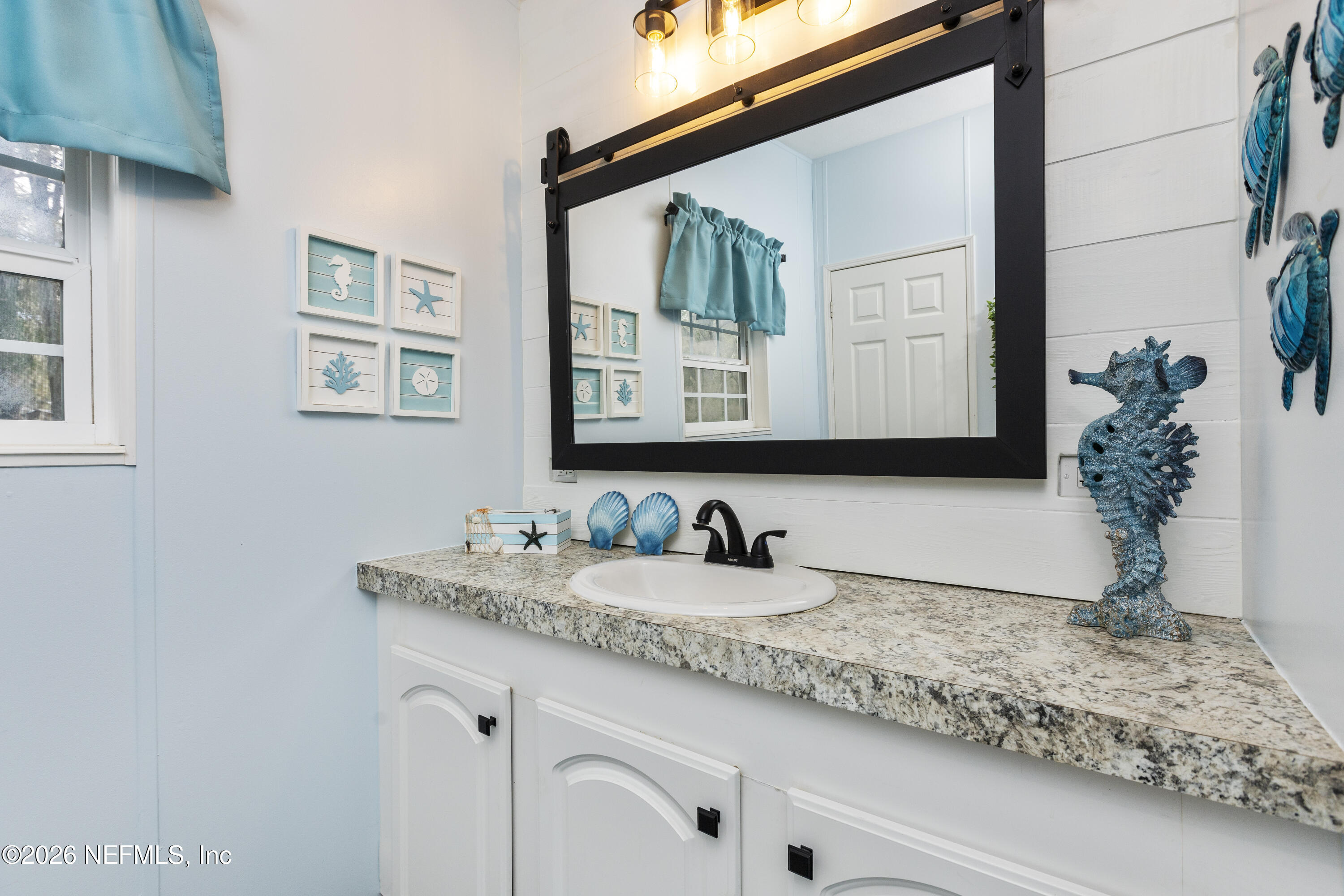 167 West Strickland Road Interlachen, FL 32148 - Photo 41 of 59 a bathroom with a sink and a mirror