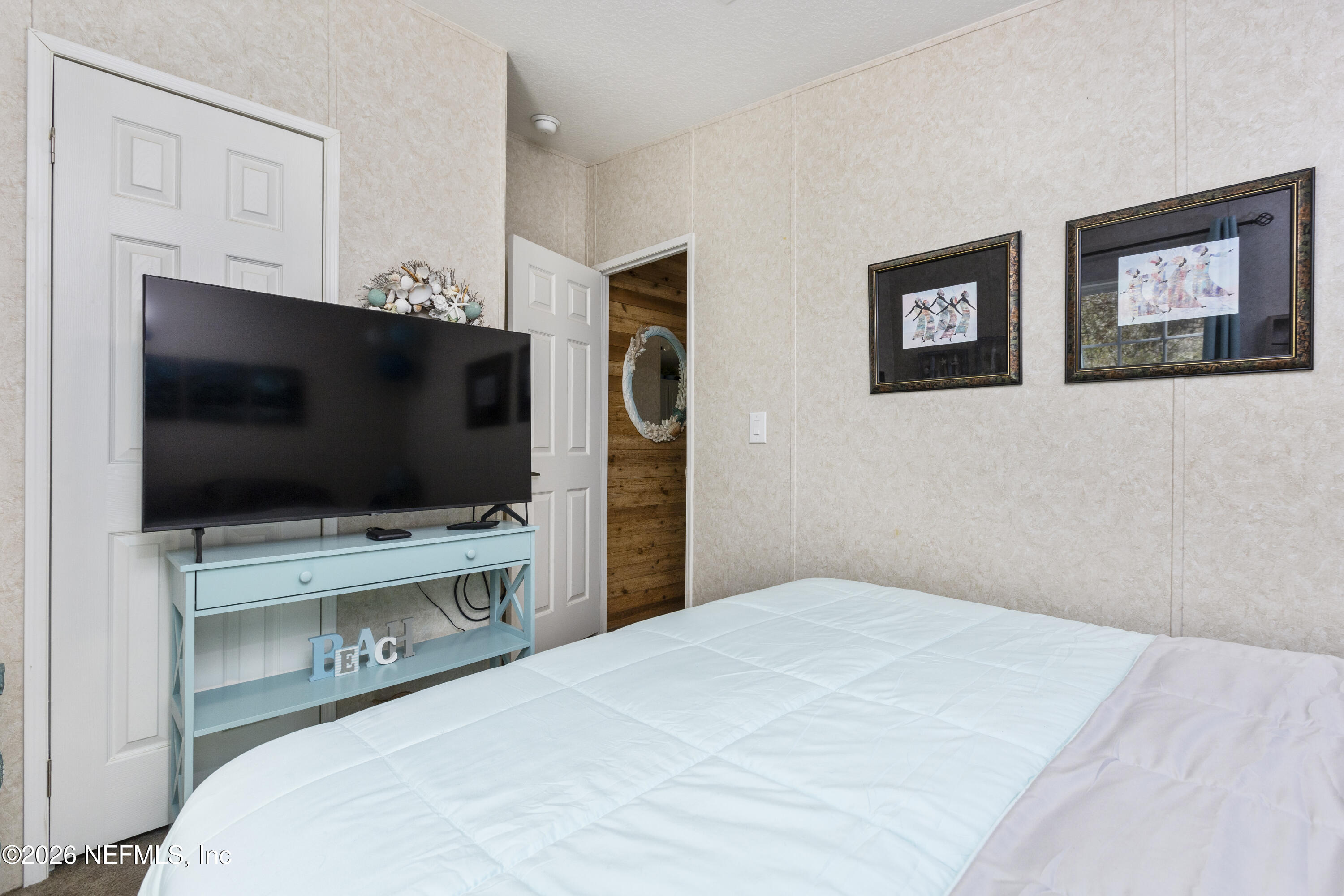 167 West Strickland Road Interlachen, FL 32148 - Photo 44 of 59 a bedroom with a bed and a flat screen tv