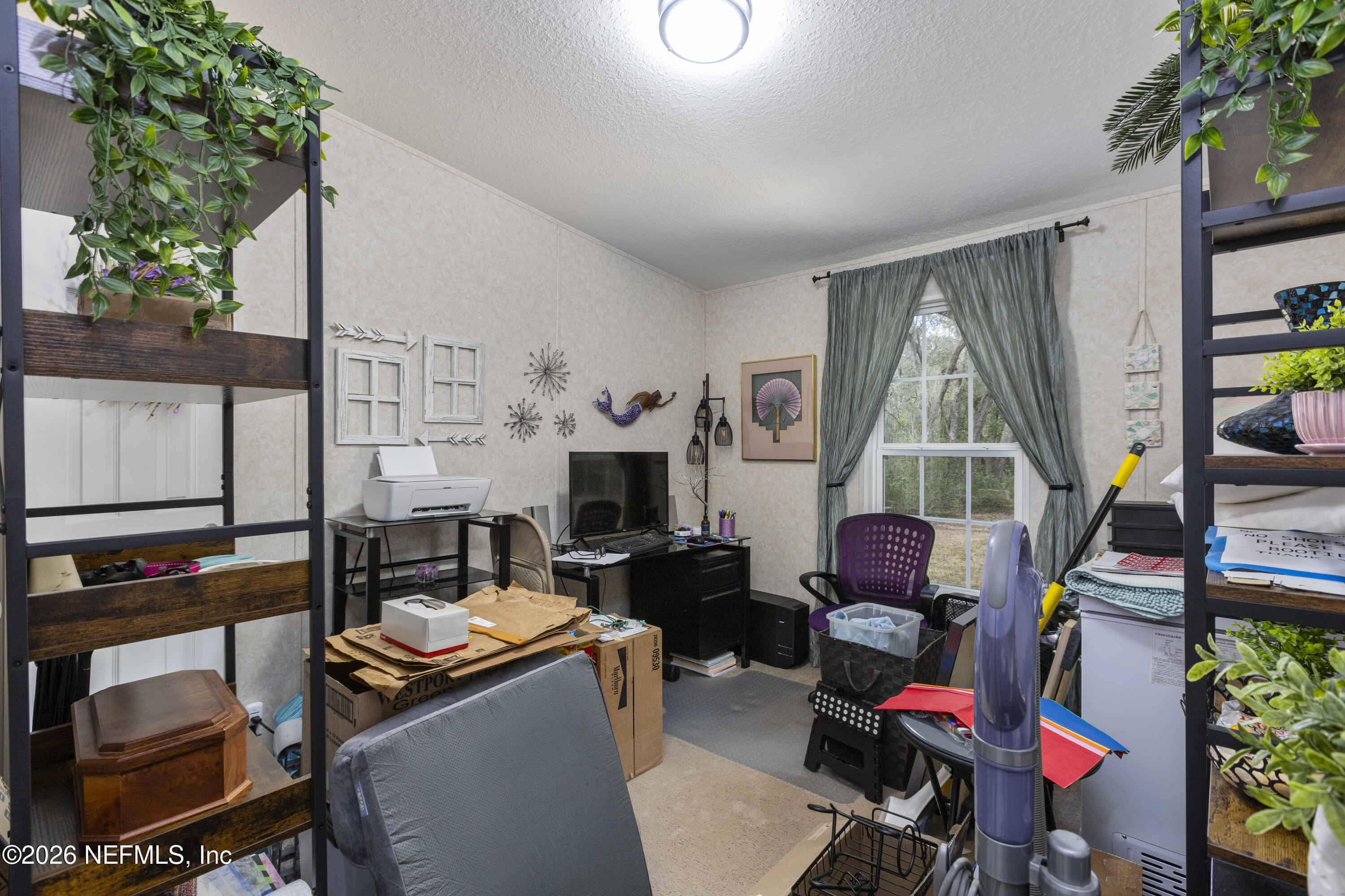 167 West Strickland Road Interlachen, FL 32148 - Photo 45 of 59 a living room with furniture a fireplace and a potted plants