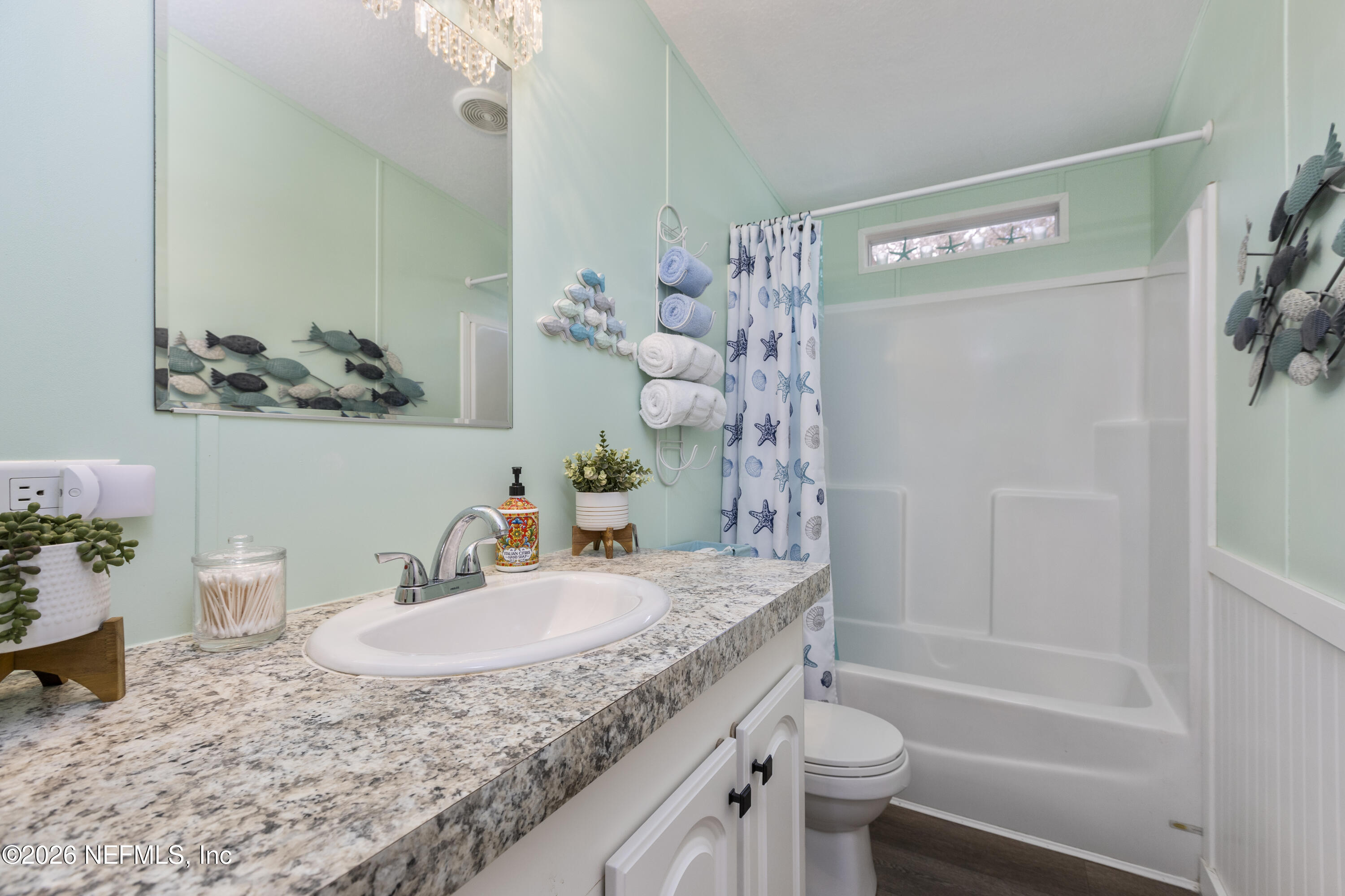 167 West Strickland Road Interlachen, FL 32148 - Photo 48 of 59 a bathroom with a granite countertop sink a toilet and shower curtain
