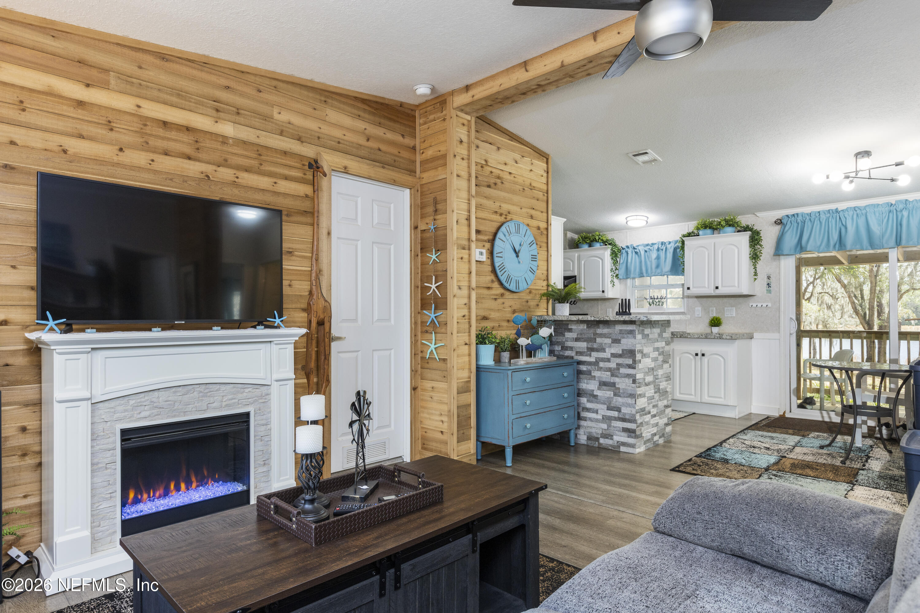 167 West Strickland Road Interlachen, FL 32148 - Photo 5 of 59 a living room with furniture a flat screen tv and a fireplace