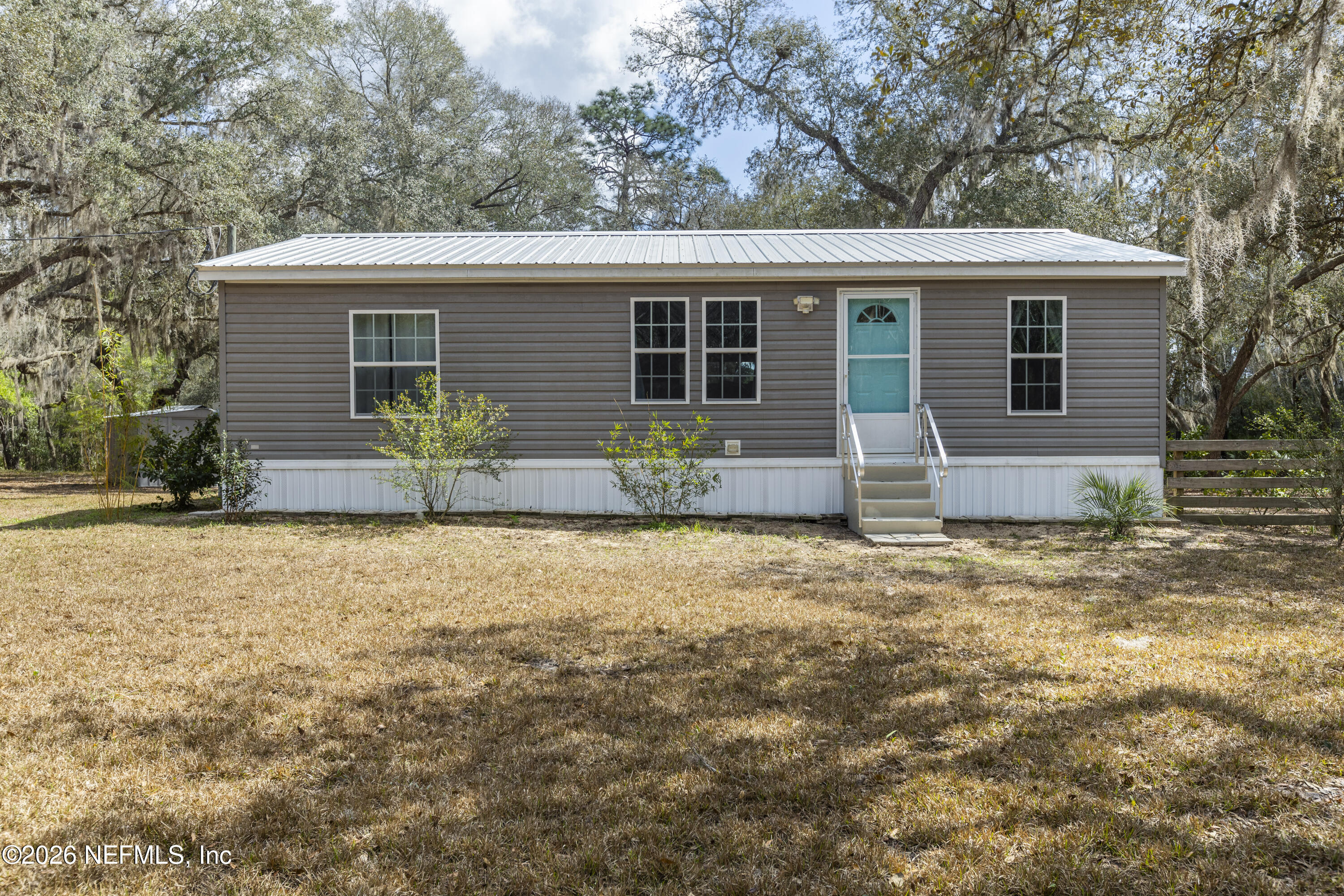 167 West Strickland Road Interlachen, FL 32148 - Photo 56 of 59 front view of house with a yard