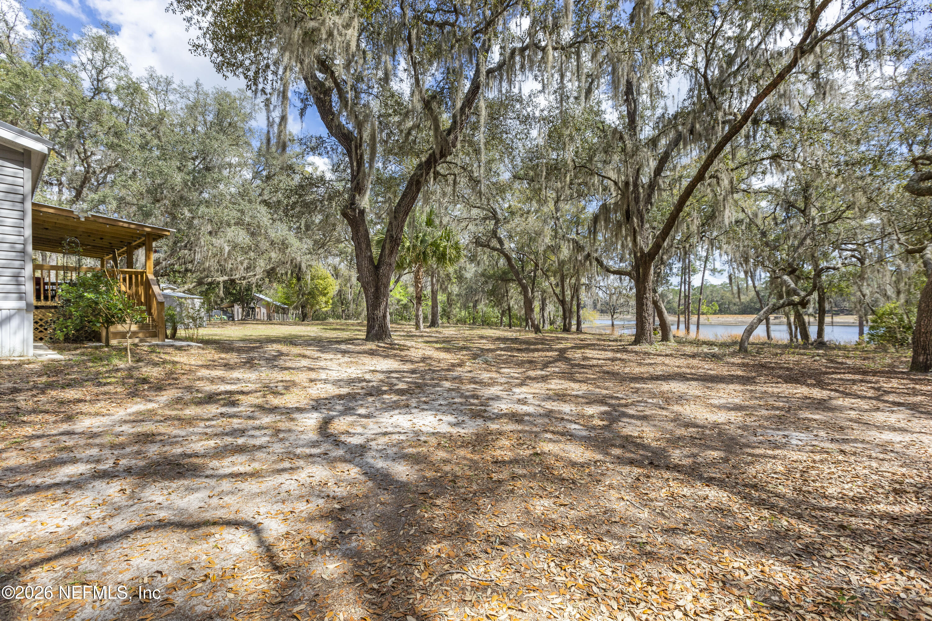 167 West Strickland Road Interlachen, FL 32148 - Photo 58 of 59 a view of outdoor space with deck and trees