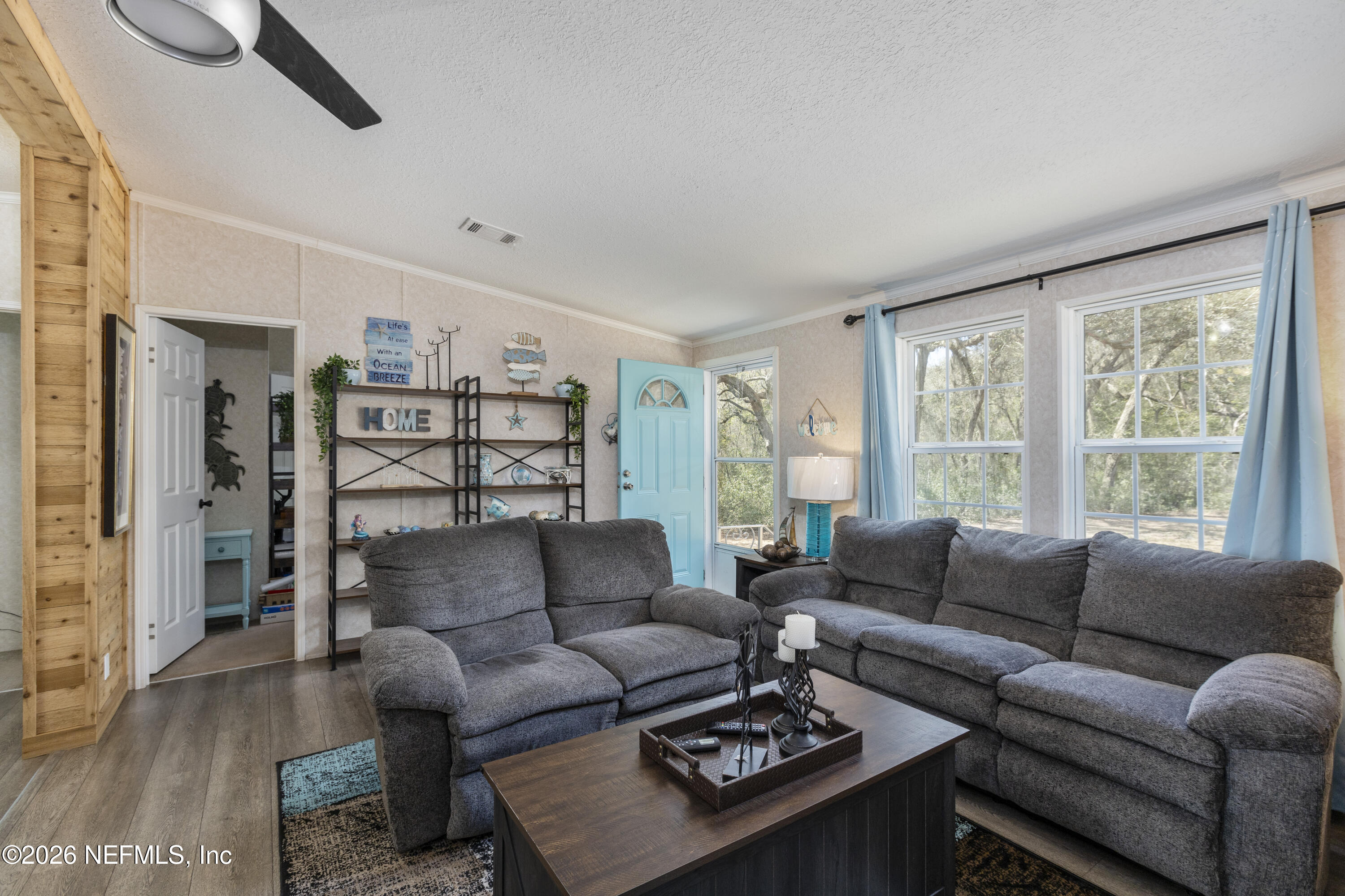 167 West Strickland Road Interlachen, FL 32148 - Photo 10 of 59 a living room with furniture and a large window