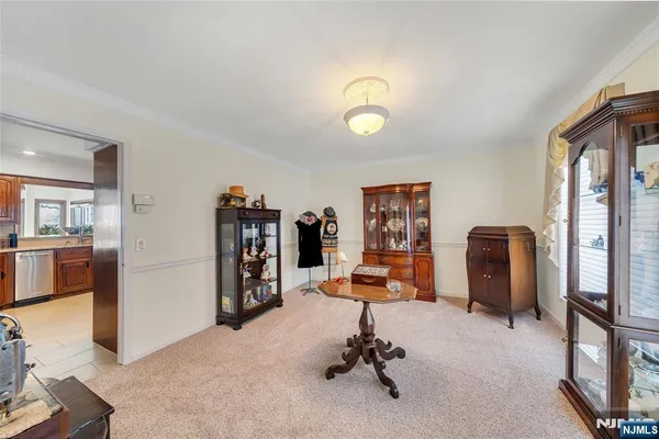 a dining area with furniture and a large window