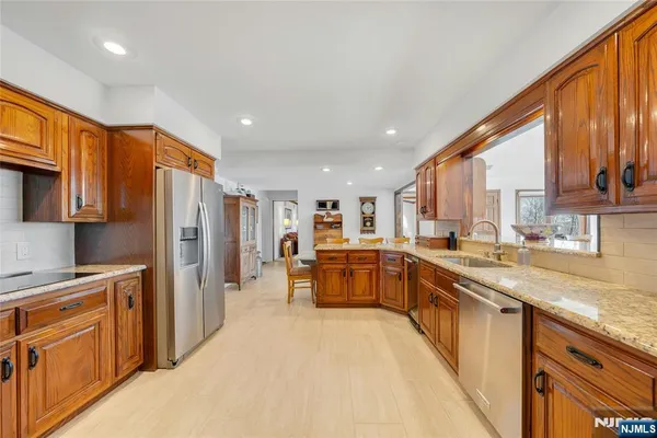 a kitchen with a sink and a wooden floor