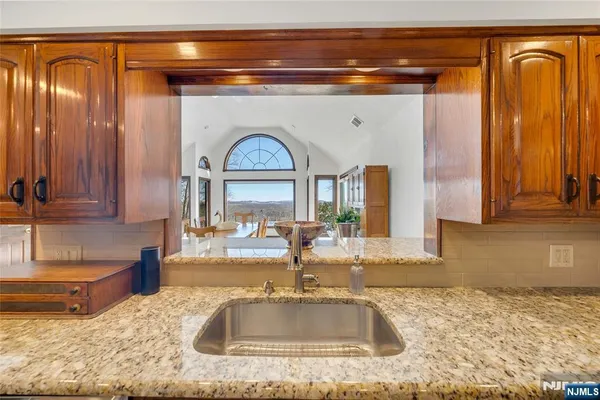 a view of a dining room with furniture a chandelier and wooden floor