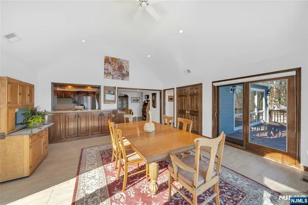 a living room with furniture a large window and a flat screen tv