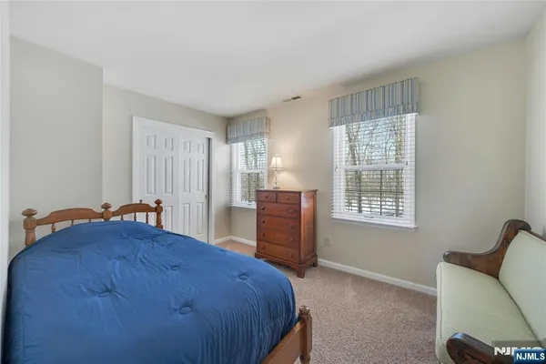 a bedroom with a bed chair and window