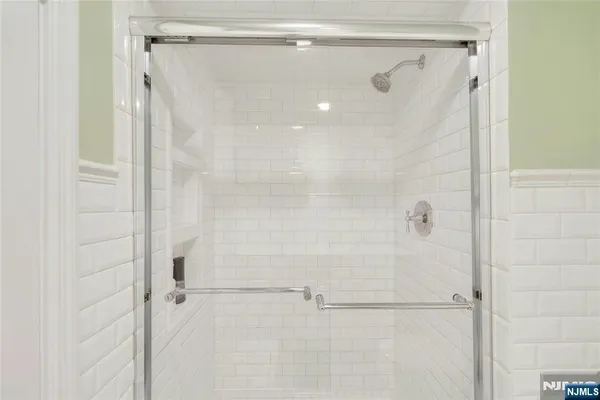 a spacious bedroom with a bed and wooden floor