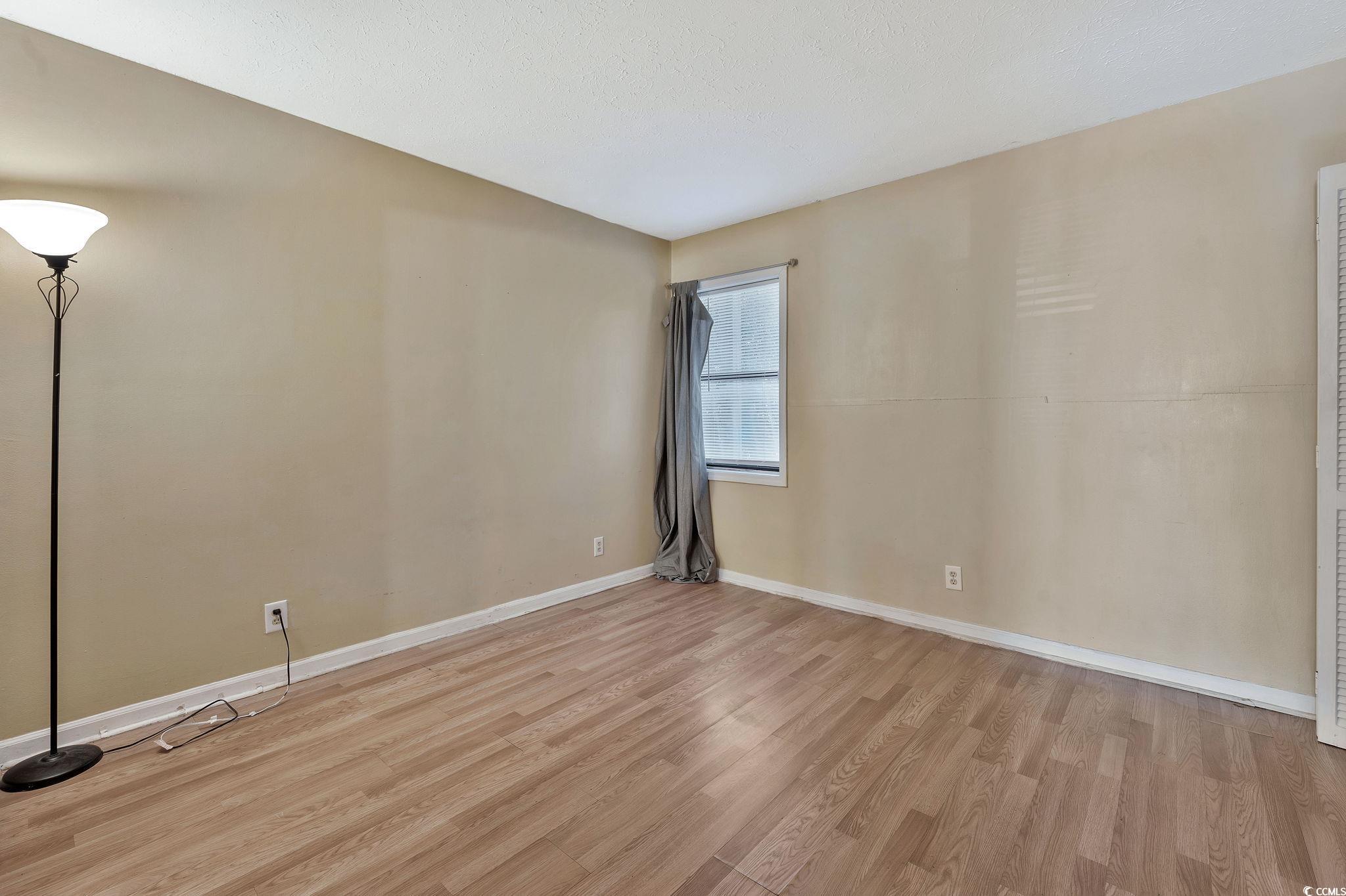 209 Cedar Street, Unit C7 Myrtle Beach, SC 29577 - Photo 11 of 13 Empty room featuring light hardwood / wood-style f