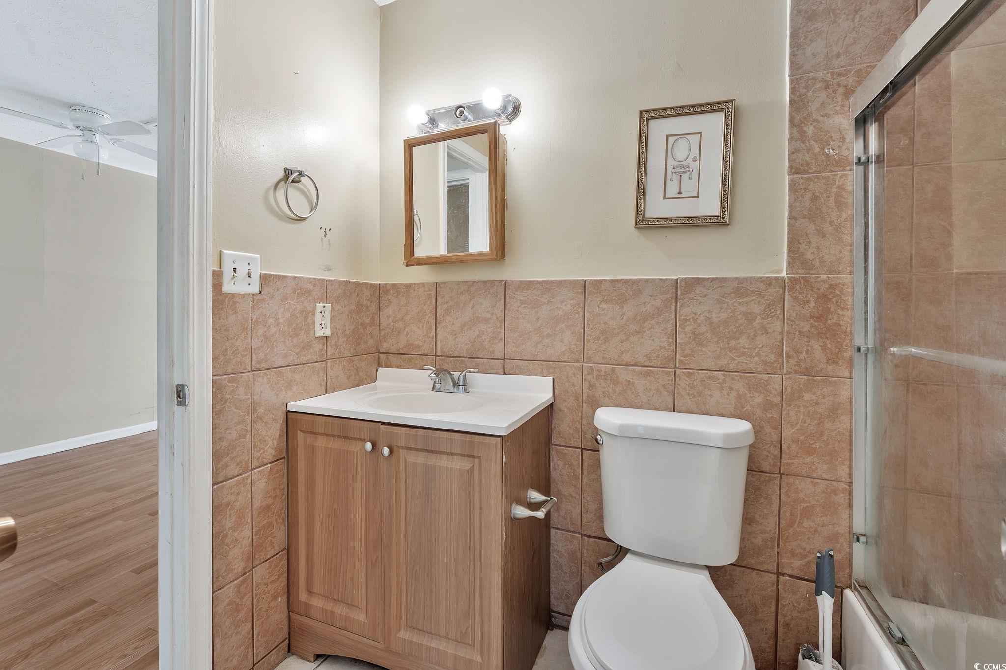 209 Cedar Street, Unit C7 Myrtle Beach, SC 29577 - Photo 12 of 13 Full bathroom featuring hardwood / wood-style floo