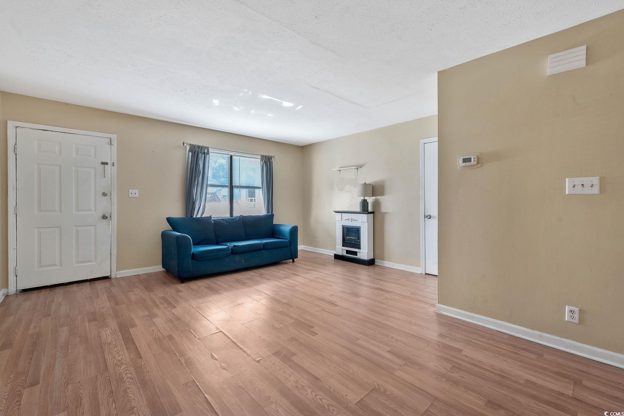 Unfurnished living room with a textured ceiling an