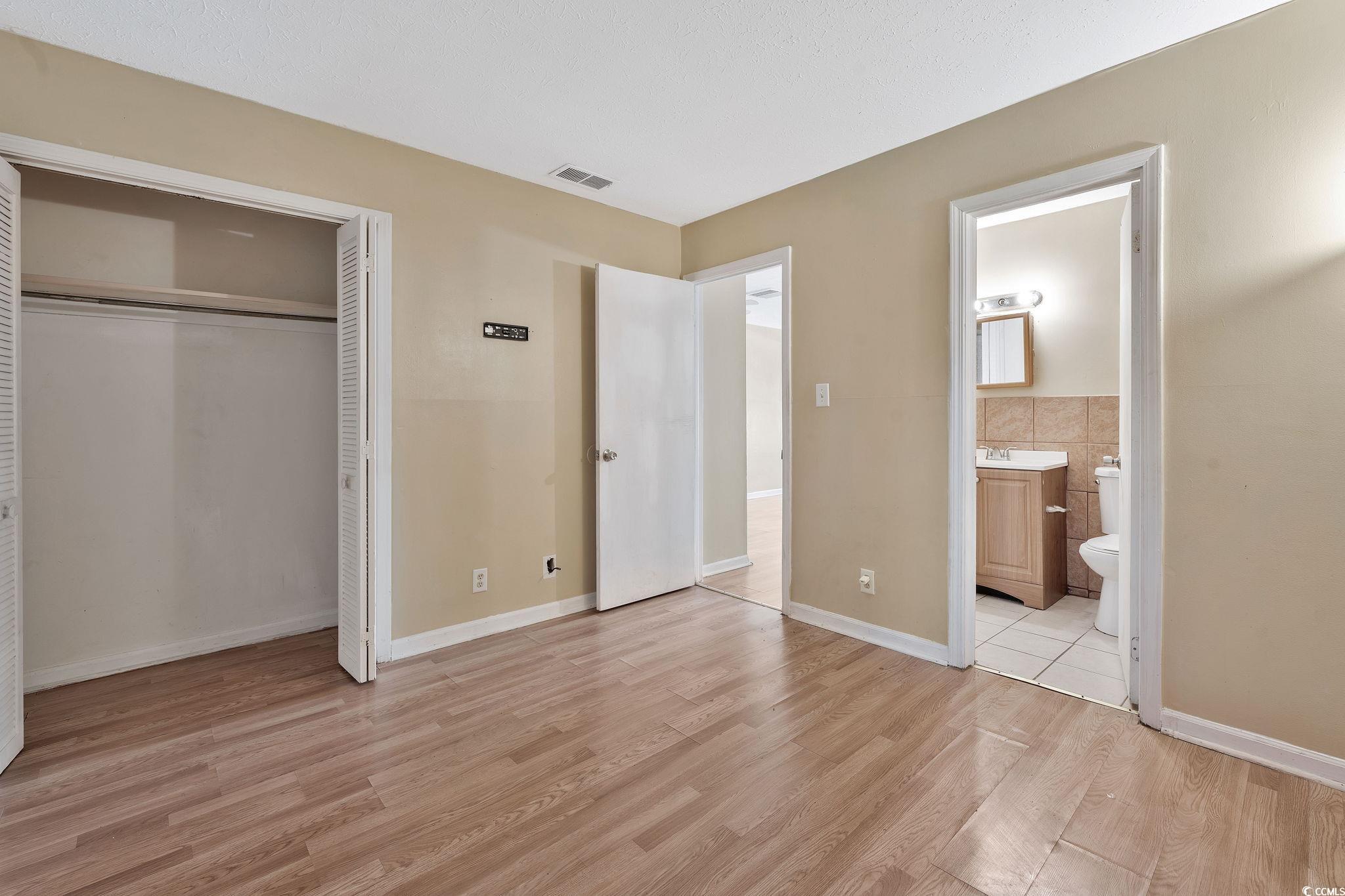 209 Cedar Street, Unit C7 Myrtle Beach, SC 29577 - Photo 10 of 13 Unfurnished bedroom featuring ensuite bathroom, a