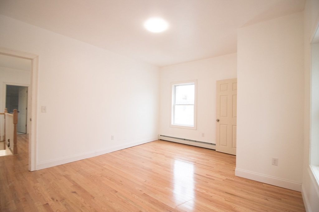 58 Willow Street Lowell, MA 01852 - Photo 13 of 21 a view of empty room with wooden floor and fan
