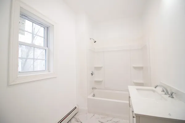 a bathroom with a bathtub and a sink