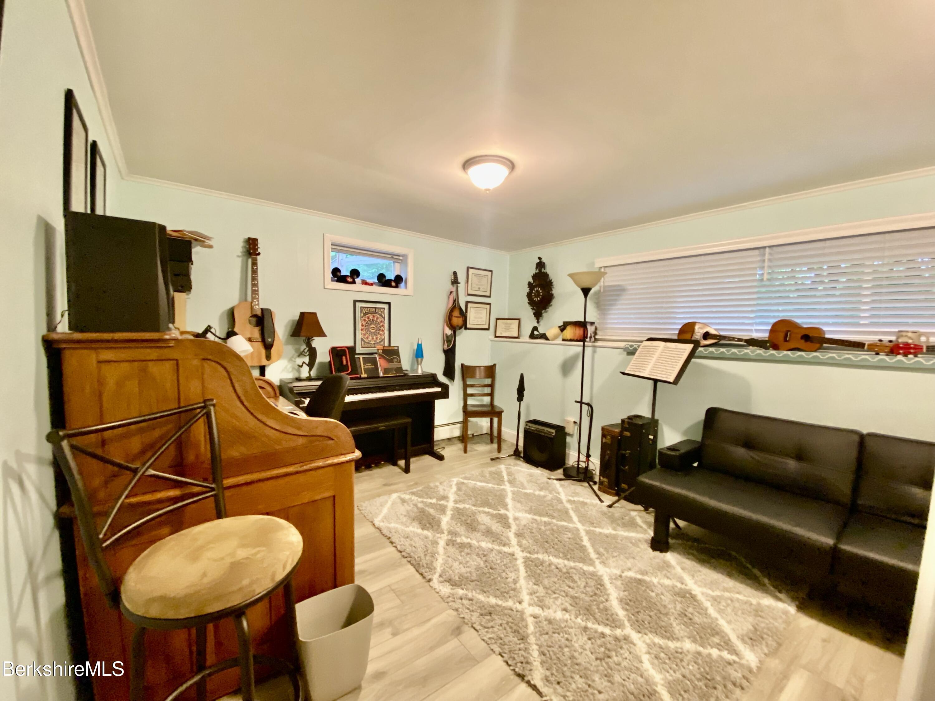 4 Devonshire Drive Cheshire, MA 01225 - Photo 32 of 48 a living room with furniture a flat screen tv and white walls