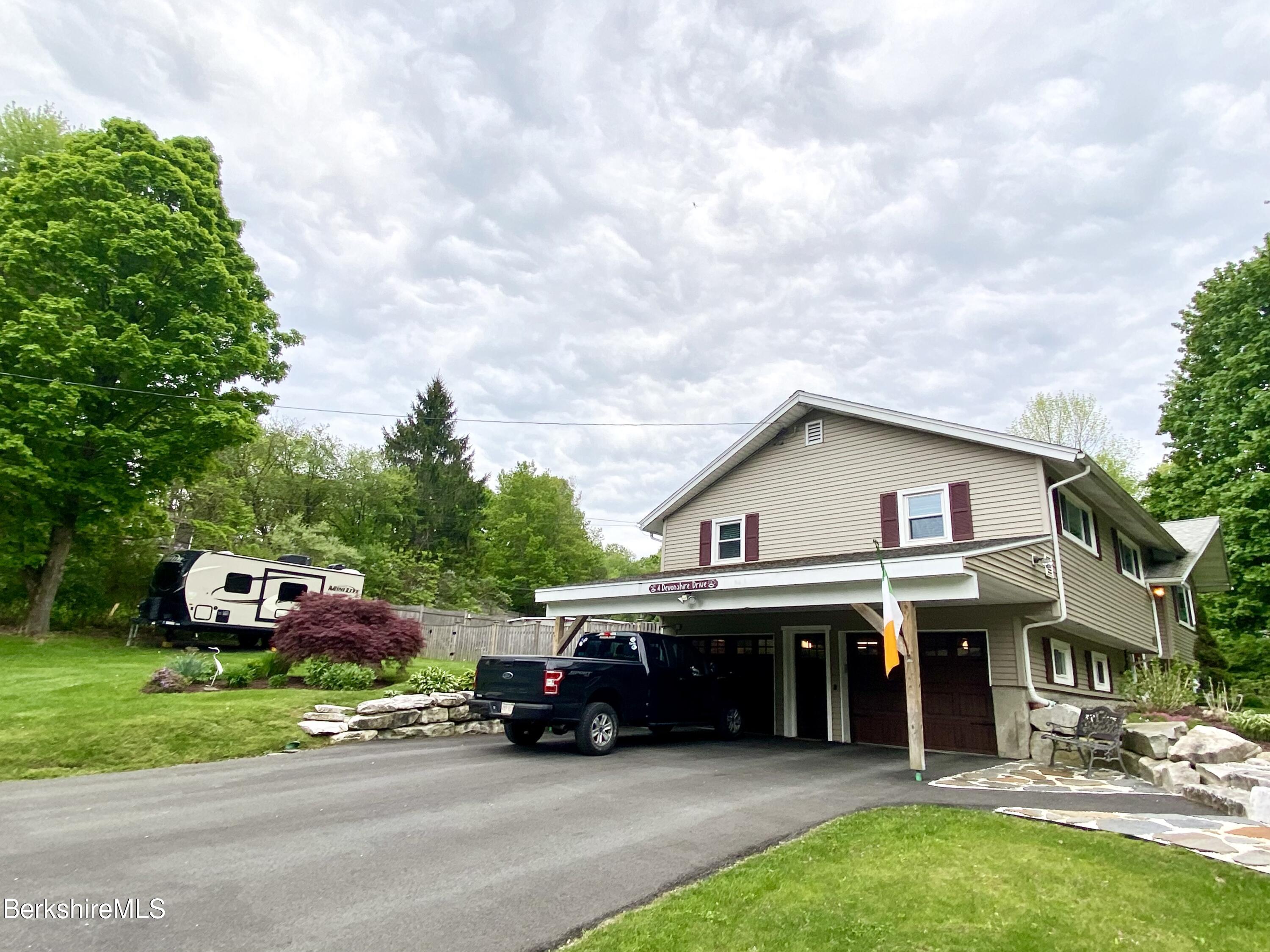 4 Devonshire Drive Cheshire, MA 01225 - Photo 36 of 48 a car parked in front of a house