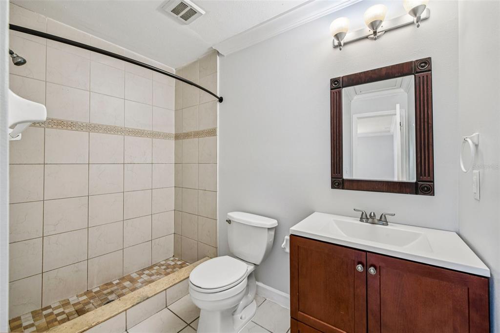 926 Lake Destiny Road, Unit F Altamonte Springs, FL 32714 - Photo 13 of 20 a bathroom with a sink a toilet and shower
