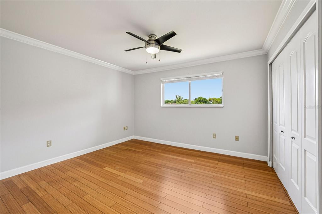 926 Lake Destiny Road, Unit F Altamonte Springs, FL 32714 - Photo 14 of 20 an empty room with wooden floor ceiling fan and windows