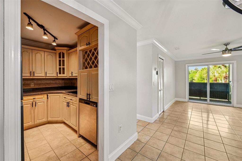 926 Lake Destiny Road, Unit F Altamonte Springs, FL 32714 - Photo 8 of 20 a view of a refrigerator in kitchen and an empty room in wooden floor