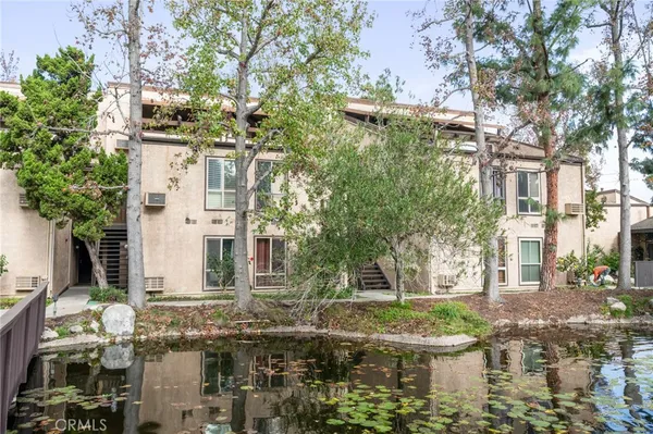 a view of residential houses with yard and tree s