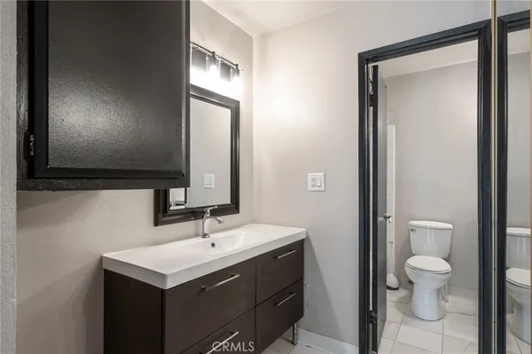 a bathroom with a toilet sink and mirror