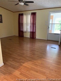 108 McIver Road Raeford, NC 28376 - Photo 12 of 40 an empty room with wooden floor and windows