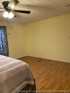 108 McIver Road Raeford, NC 28376 - Photo 20 of 40 a bedroom with a bed and a chandelier