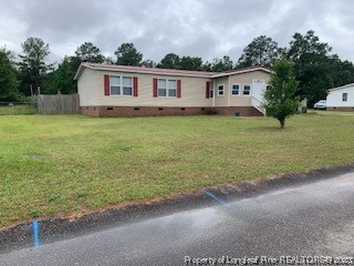 108 McIver Road Raeford, NC 28376 - Photo 2 of 40 a view of a house with a backyard and a garden