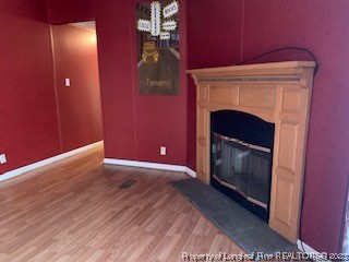 108 McIver Road Raeford, NC 28376 - Photo 6 of 40 a view of an empty room with wooden floor and a fireplace