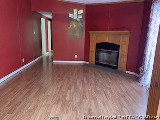 108 McIver Road Raeford, NC 28376 - Photo 7 of 40 a view of an empty room with wooden floor and a fireplace