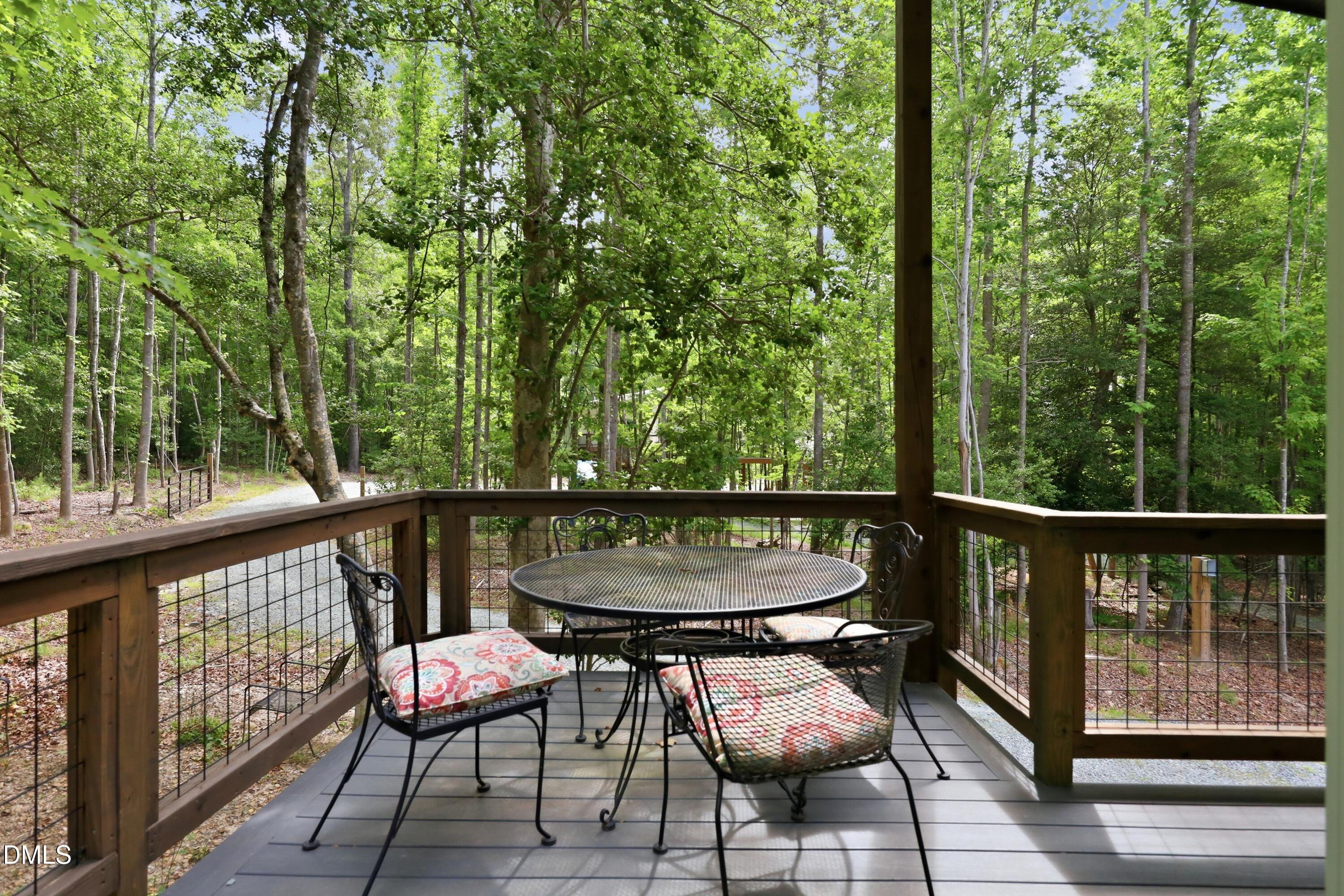 286 Stone Wall Road Pittsboro, NC 27312 - Photo 25 of 71 a balcony with wooden floor and outdoor seating