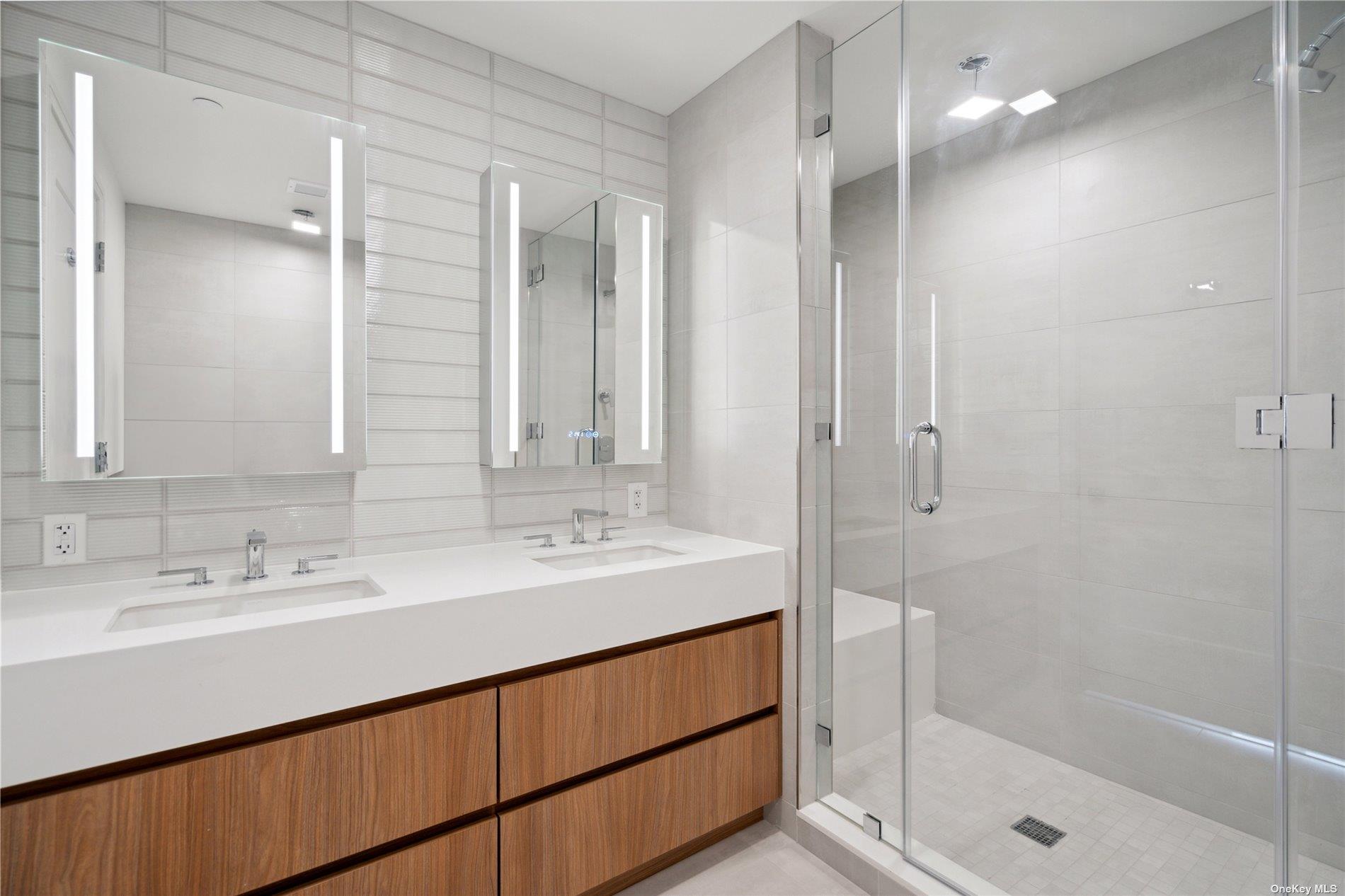 218 Middle Neck Road, Unit 107 Great Neck, NY 11021 - Photo 8 of 32 a bathroom with a shower sink and mirror