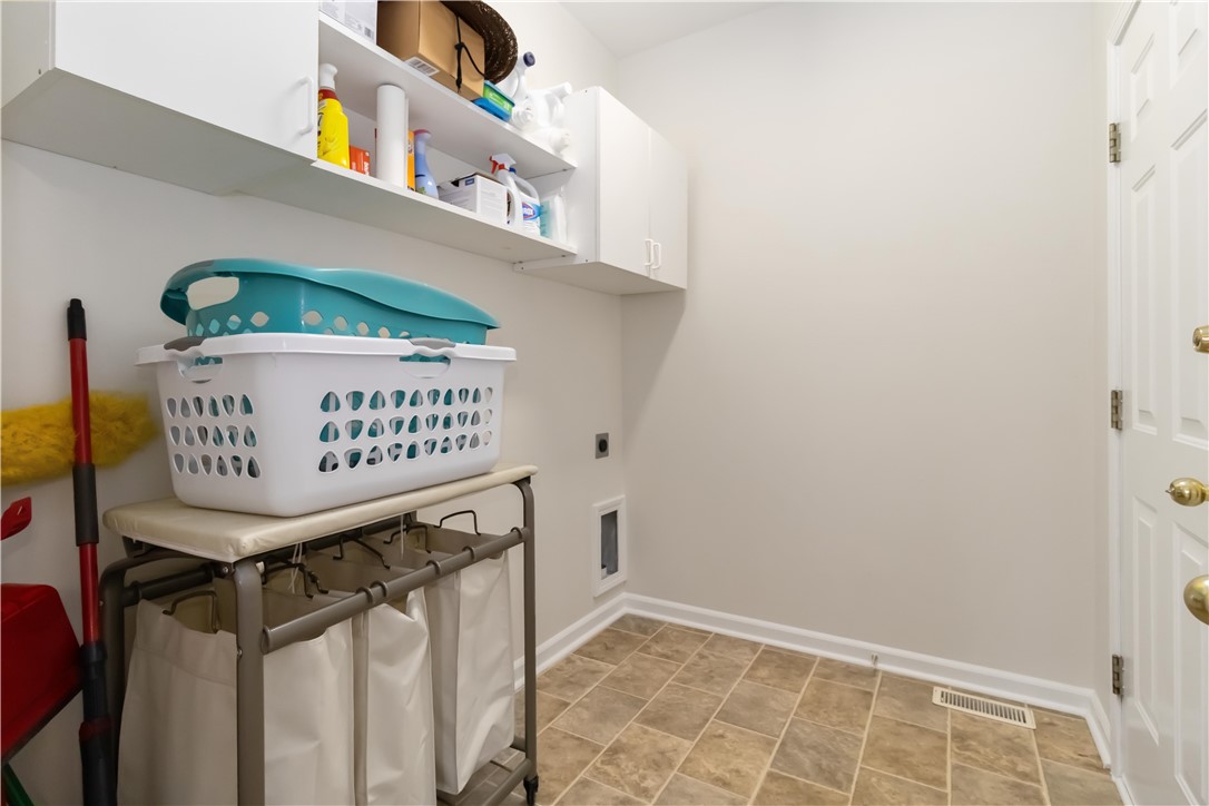 215 Ridge Bay Court Greenville, SC 29611 - Photo 17 of 34 Functional laundry space with convenient shelving for all your household needs.