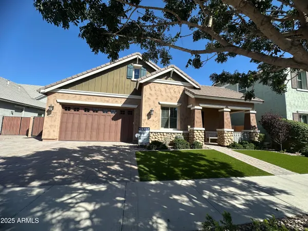 a front view of a house with a garden and yard