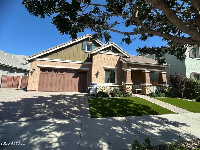 a front view of a house with a garden and yard